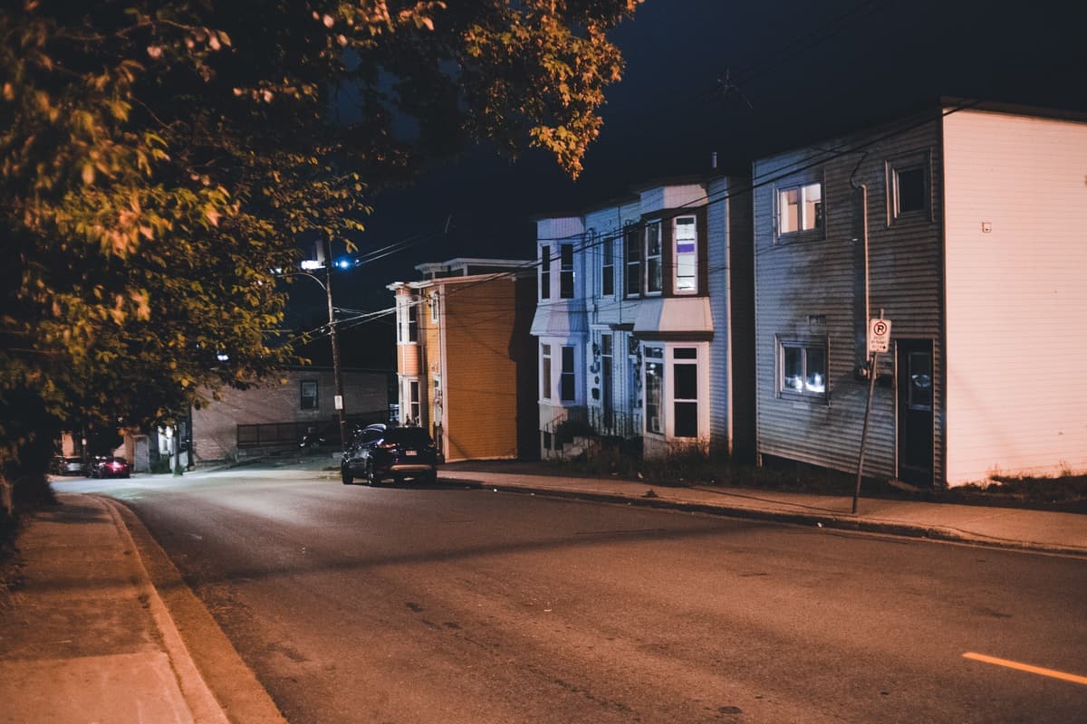 A street of houses decorated with lights in the evening