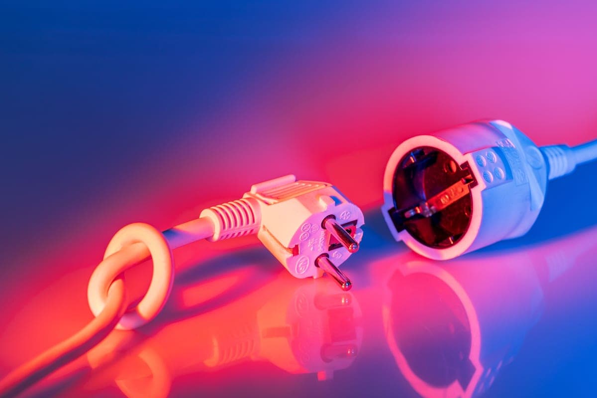 An outdoor electrical outlet with an extension cord plugged in